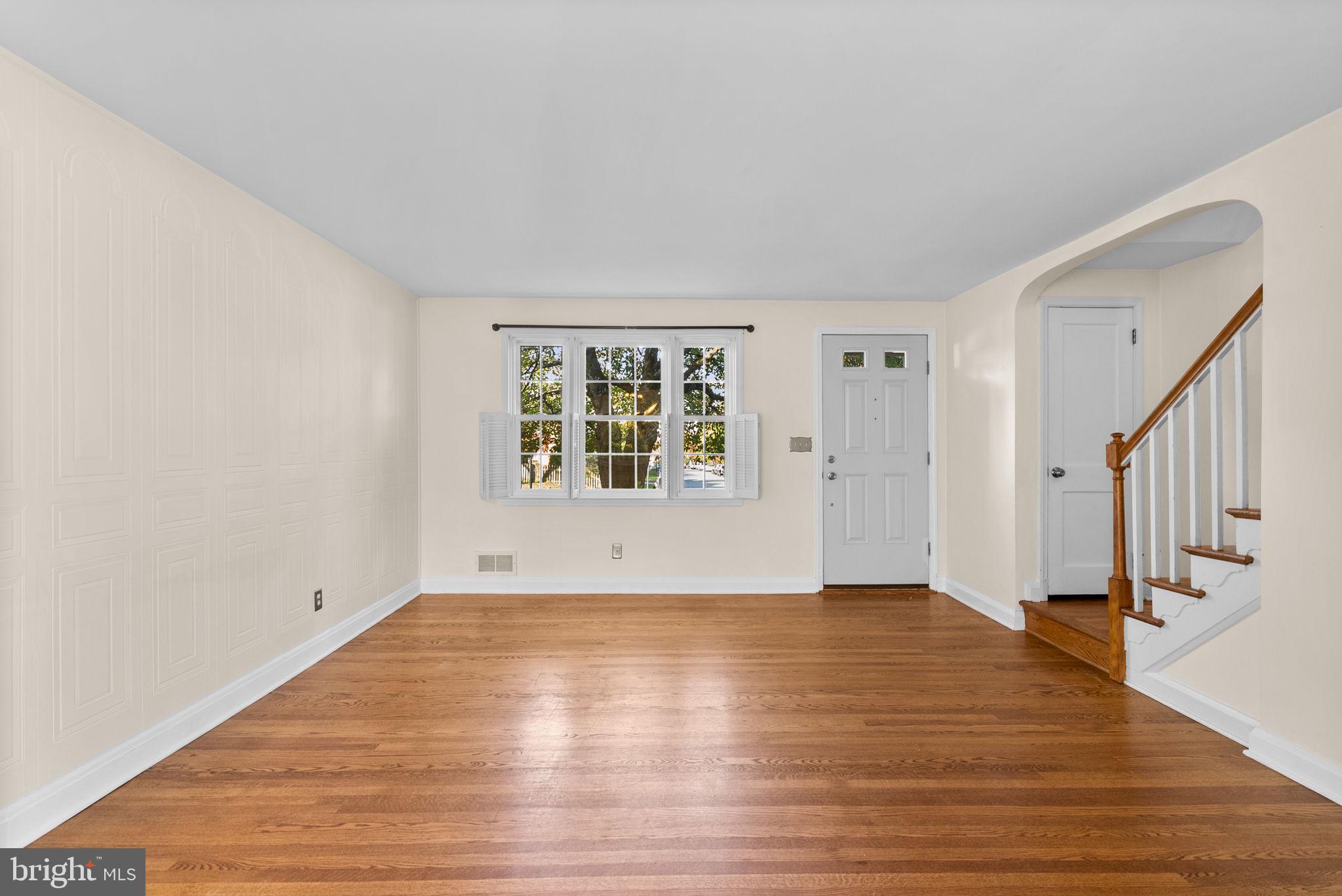 324 Stanmore Road Baltimore, MD 21212 - Photo 7 of 40 a view of an empty room with wooden floor and a window