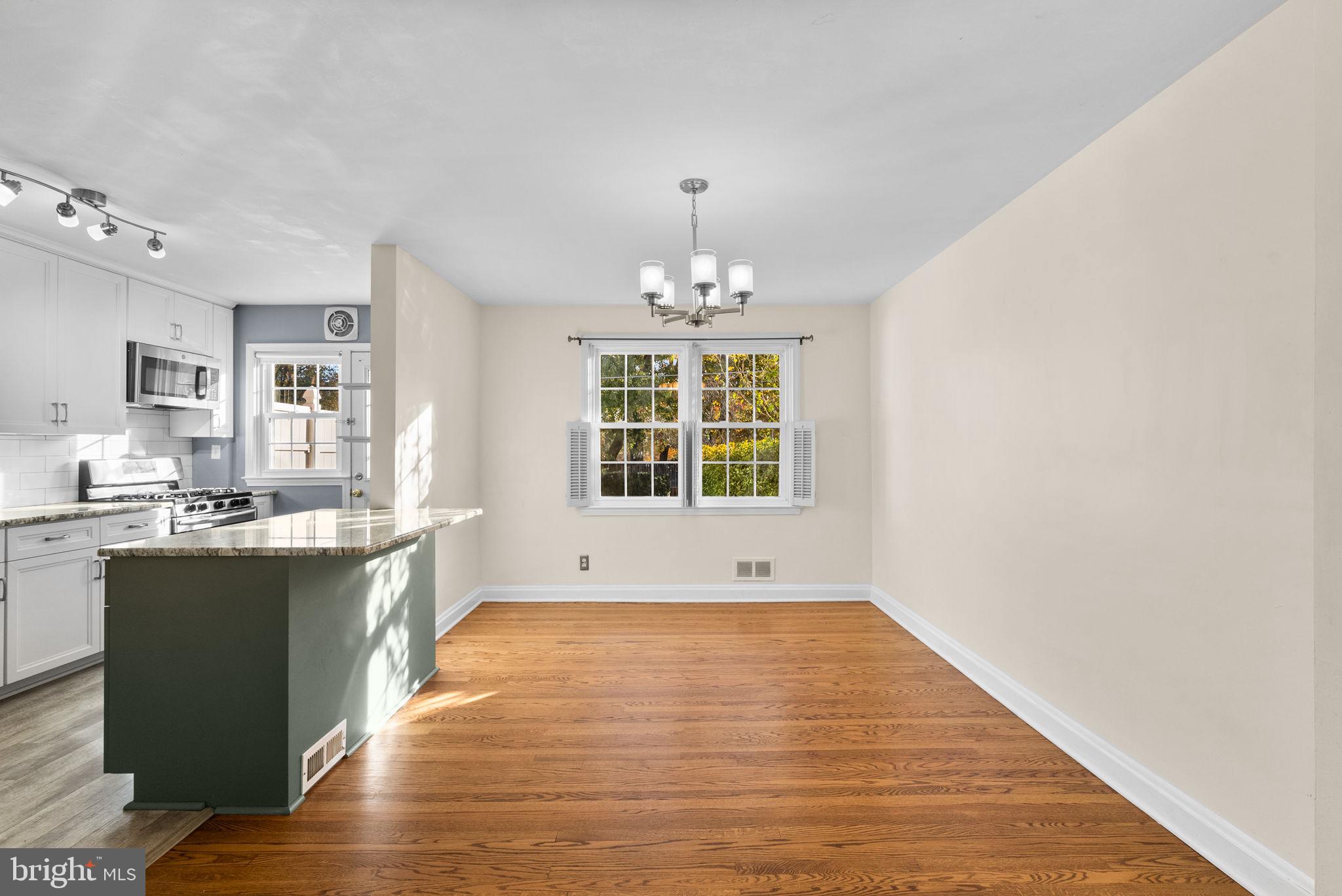 324 Stanmore Road Baltimore, MD 21212 - Photo 8 of 40 a view of a room with wooden floor and kitchen