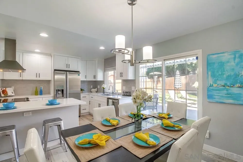 515 Bluffview Road Spring Valley, CA 91977 - Photo 11 of 41 a open dining room with stainless steel appliances kitchen island furniture and a chandelier