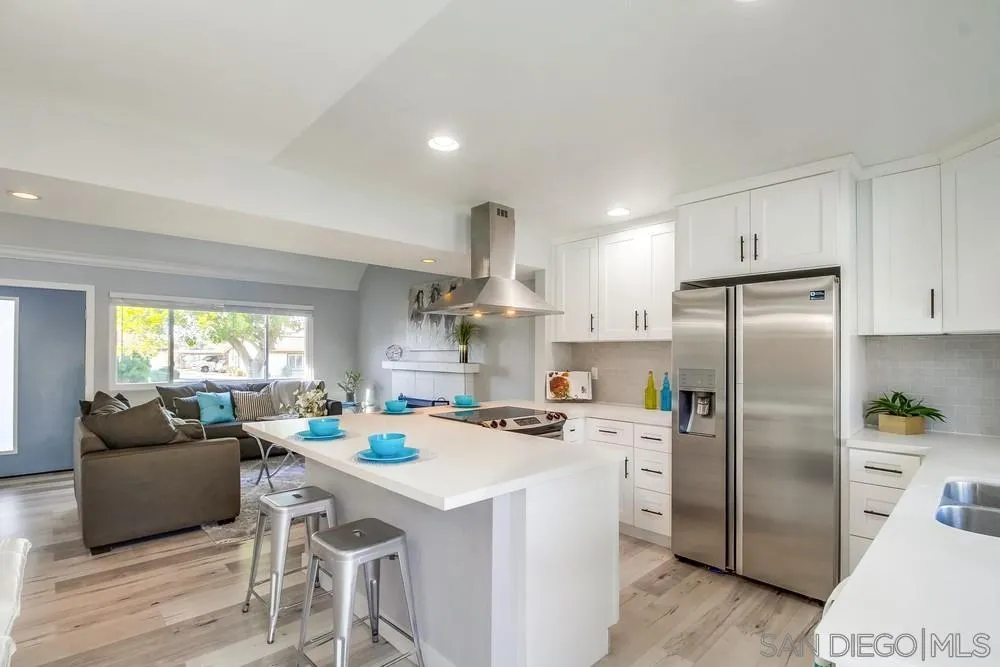 515 Bluffview Road Spring Valley, CA 91977 - Photo 12 of 41 a kitchen that has a lot of cabinets a sink and appliances in it