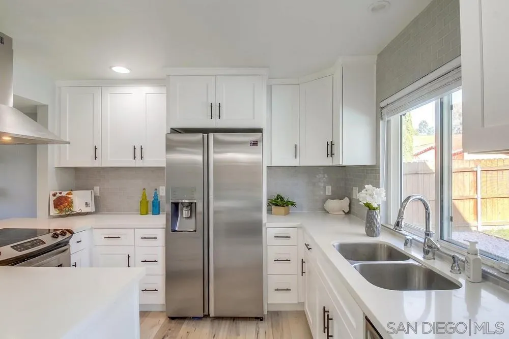 515 Bluffview Road Spring Valley, CA 91977 - Photo 13 of 41 a kitchen with stainless steel appliances a refrigerator sink and cabinets