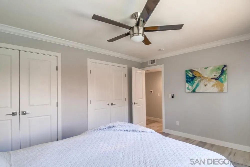 515 Bluffview Road Spring Valley, CA 91977 - Photo 21 of 41 a bedroom with a bed and a chandelier