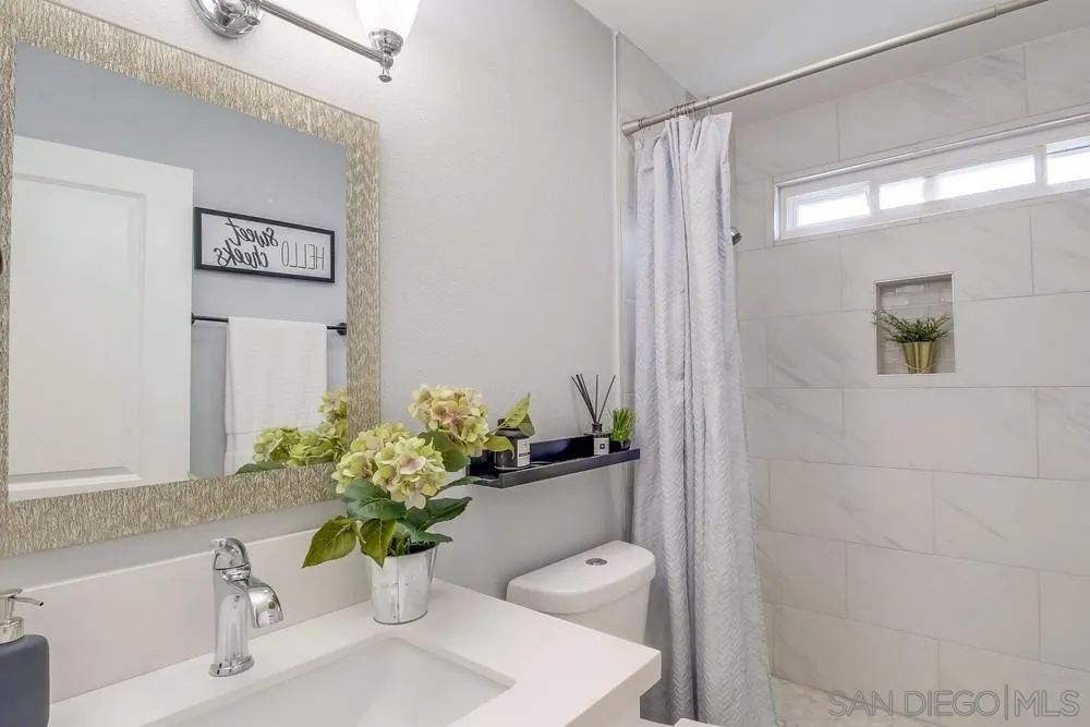 515 Bluffview Road Spring Valley, CA 91977 - Photo 22 of 41 a bathroom with a shower a toilet and a sink
