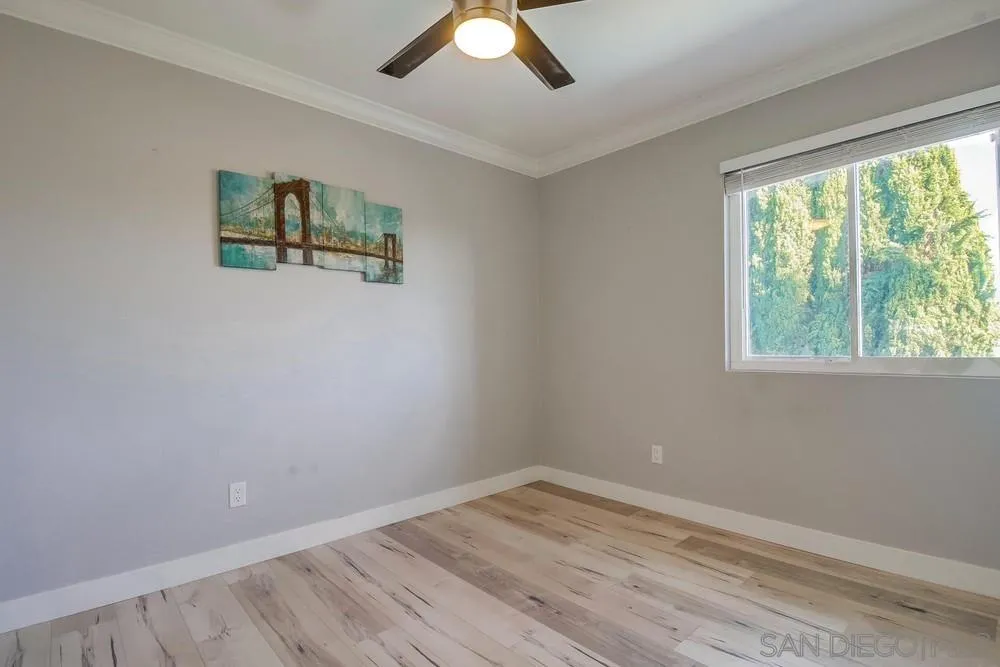 515 Bluffview Road Spring Valley, CA 91977 - Photo 30 of 41 a view of empty room with wooden floor and fan