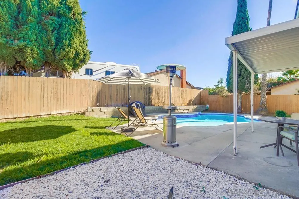 515 Bluffview Road Spring Valley, CA 91977 - Photo 32 of 41 a view of a backyard with couches under an umbrella