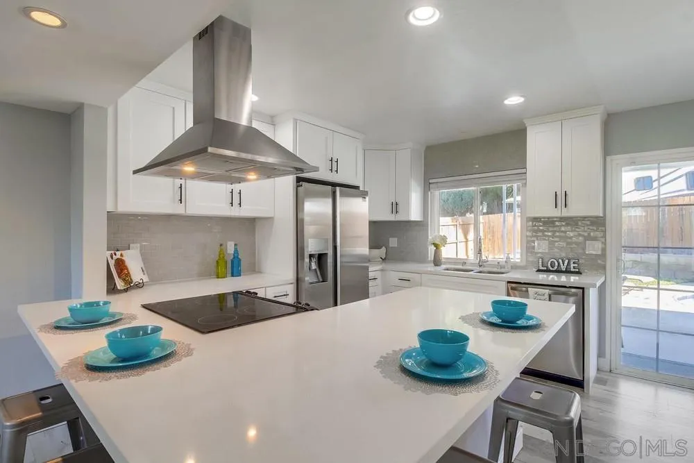 515 Bluffview Road Spring Valley, CA 91977 - Photo 8 of 41 a kitchen with stainless steel appliances granite countertop a sink a stove and a refrigerator