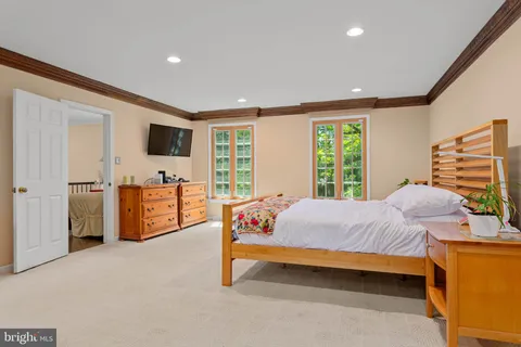 a bedroom with a bed and flat screen tv
