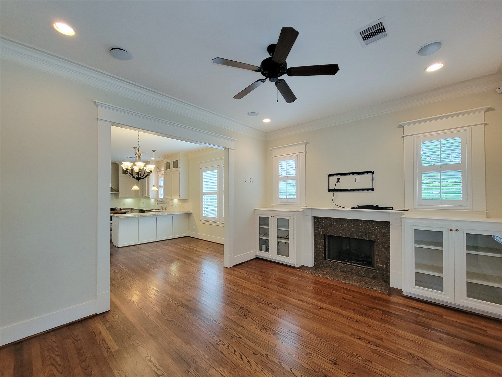 1140 West Cottage Street Houston, TX 77009 - Photo 8 of 37 a view of empty room with wooden floor and fireplace