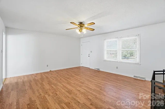 a view of a room with a window and a ceiling fan