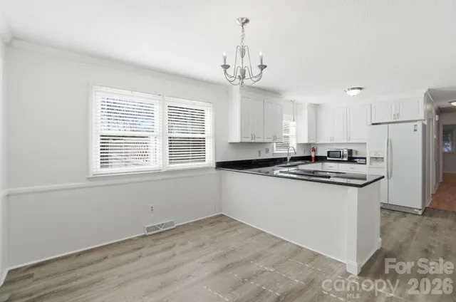 a kitchen with a sink stove and refrigerator