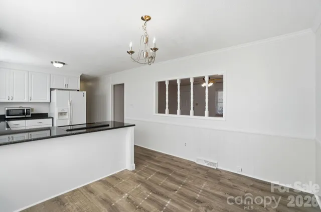 a view of a kitchen with stainless steel appliances granite countertop a stove and a sink