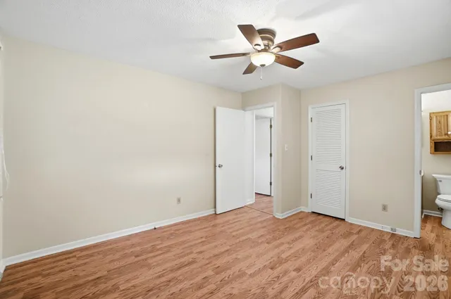 a view of a livingroom with a ceiling fan and wooden floor