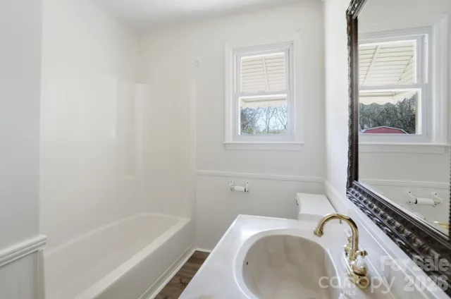 a bathroom with a tub sink and toilet