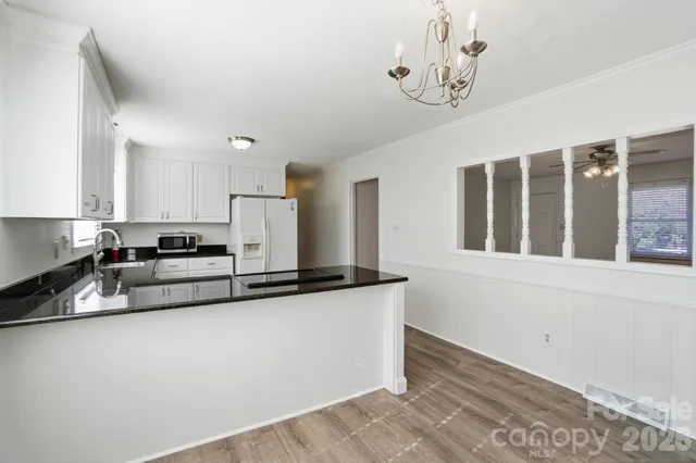 a kitchen with stainless steel appliances granite countertop a sink a stove and a granite counter tops