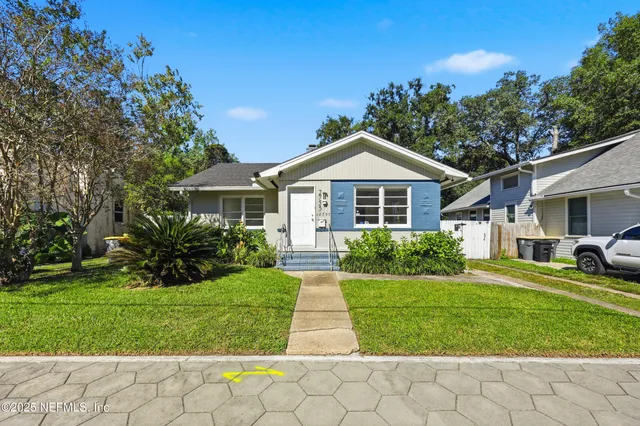 a front view of a house with a yard and porch