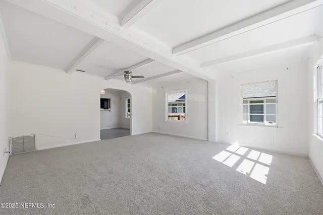 a large kitchen with stainless steel appliances kitchen island granite countertop a stove and a sink