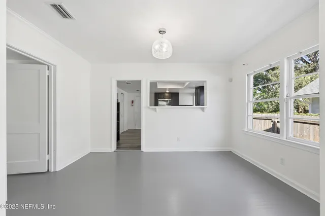 an empty room with a ceiling fan and wooden floor