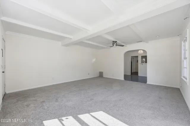 a kitchen with granite countertop a refrigerator and a stove top oven