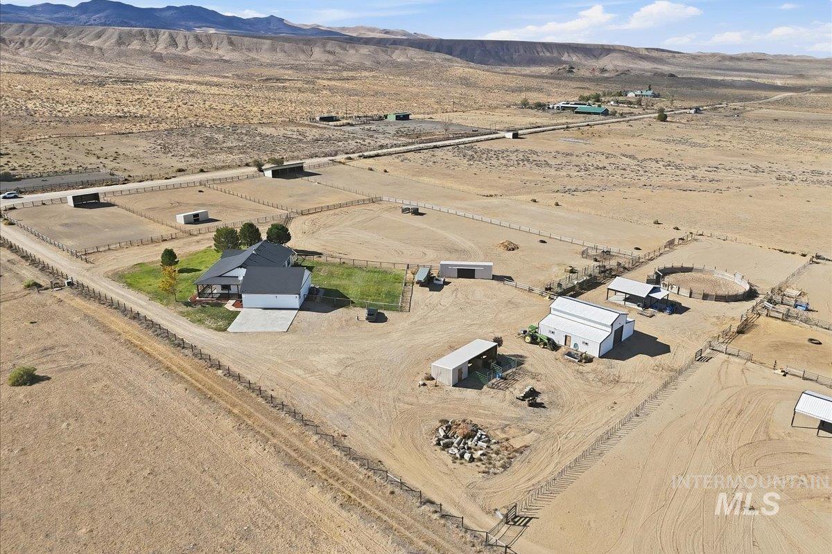18026 Briar Creek Road Murphy, ID 83650 - Photo 44 of 50 Expansive property featuring multiple outbuildings, a covered open-air structure, a round pen, and extensive fencing