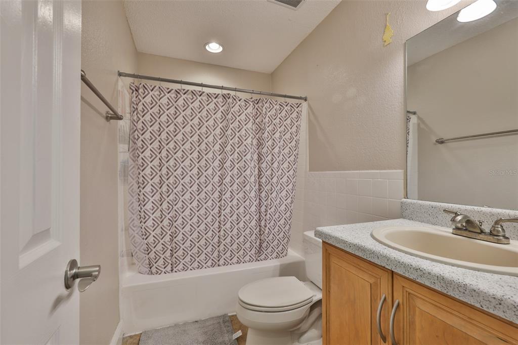 13125 Wilcox Road, Unit 16202 Largo, FL 33774 - Photo 11 of 37 a bathroom with a granite countertop sink toilet and shower