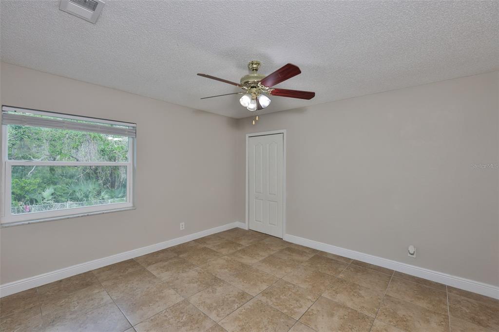 13125 Wilcox Road, Unit 16202 Largo, FL 33774 - Photo 12 of 37 a view of an empty room with a window
