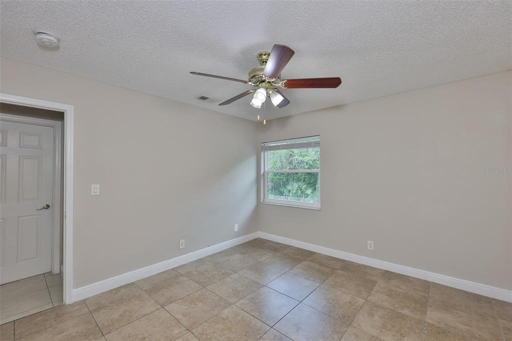 13125 Wilcox Road, Unit 16202 Largo, FL 33774 - Photo 13 of 37 an empty room with a window and a fan