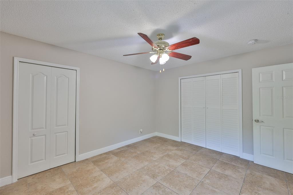 13125 Wilcox Road, Unit 16202 Largo, FL 33774 - Photo 14 of 37 an empty room with closet and fan