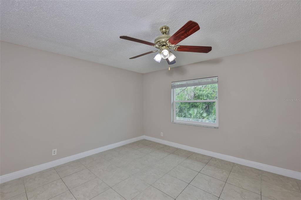 13125 Wilcox Road, Unit 16202 Largo, FL 33774 - Photo 19 of 37 an empty room with a window and a fan