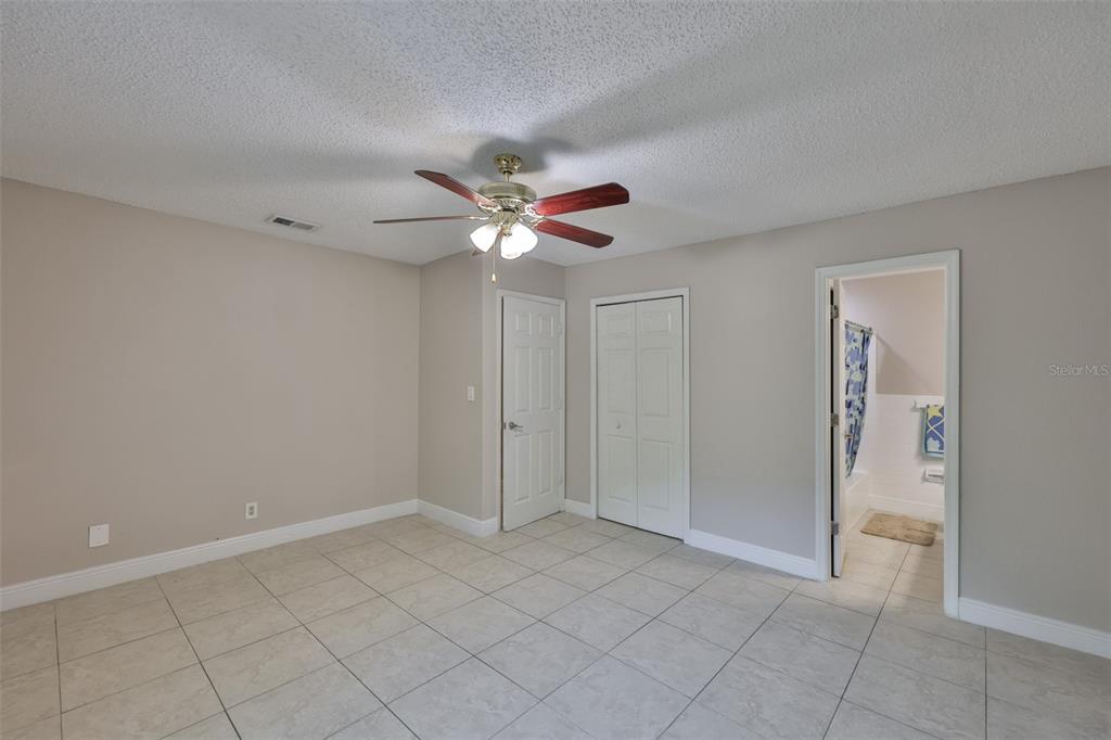 13125 Wilcox Road, Unit 16202 Largo, FL 33774 - Photo 21 of 37 an empty room with closet and a ceiling fan