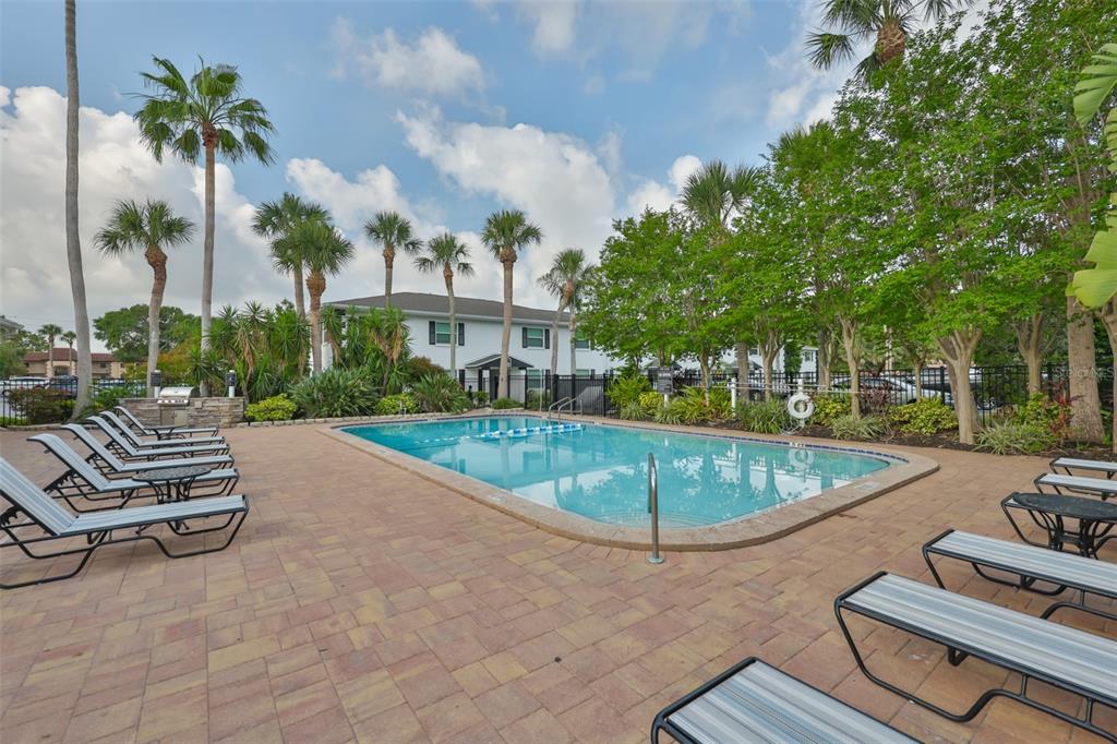 13125 Wilcox Road, Unit 16202 Largo, FL 33774 - Photo 25 of 37 a swimming pool with outdoor seating and yard