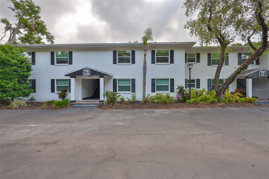 13125 Wilcox Road, Unit 16202 Largo, FL 33774 - Photo 28 of 37 a front view of a house with a yard and garage