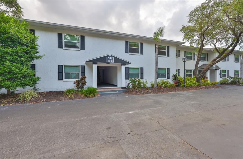 13125 Wilcox Road, Unit 16202 Largo, FL 33774 - Photo 29 of 37 a front view of a house with a yard and garage