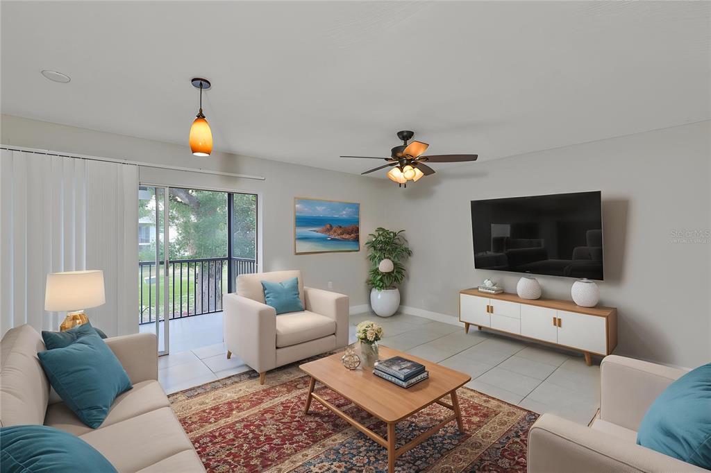 13125 Wilcox Road, Unit 16202 Largo, FL 33774 - Photo 3 of 37 a living room with furniture and a flat screen tv