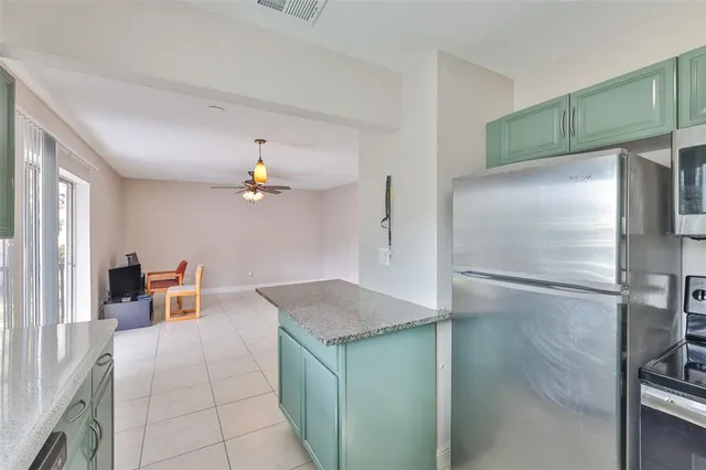 a kitchen with a refrigerator and a sink