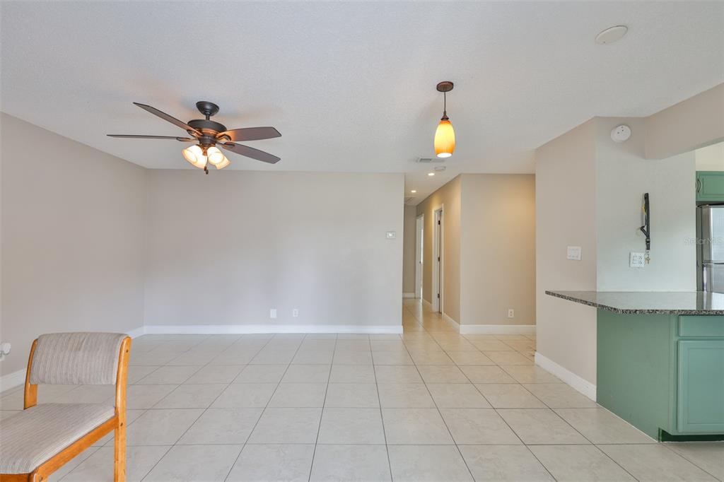 13125 Wilcox Road, Unit 16202 Largo, FL 33774 - Photo 10 of 37 a view of an empty room and chandelier fan