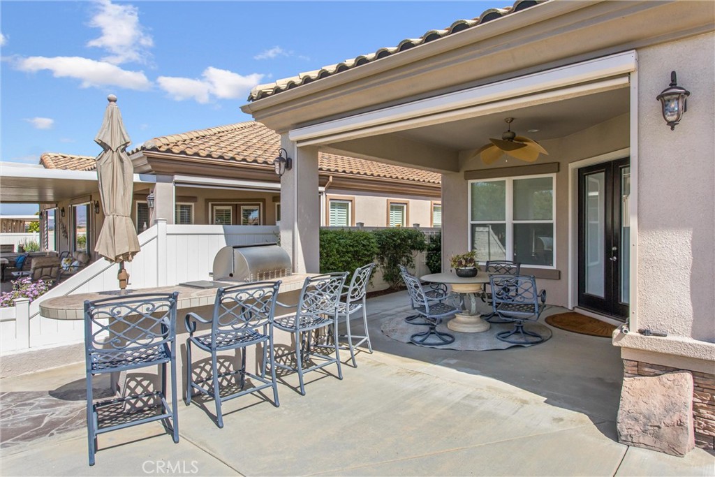 5233 Hampton Road Banning, CA 92220 - Photo 33 of 46 a view of a dinning table and chairs in patio of the house