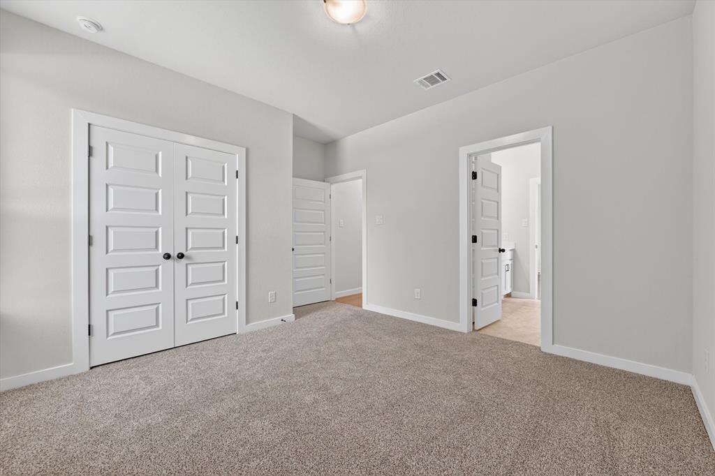 409 Mcalpine Springtown, TX 76082 - Photo 28 of 38 Light gray wall paint complemented by white trim and a neutral carpet