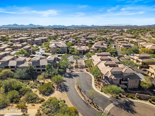 an aerial view of residential building and trees around