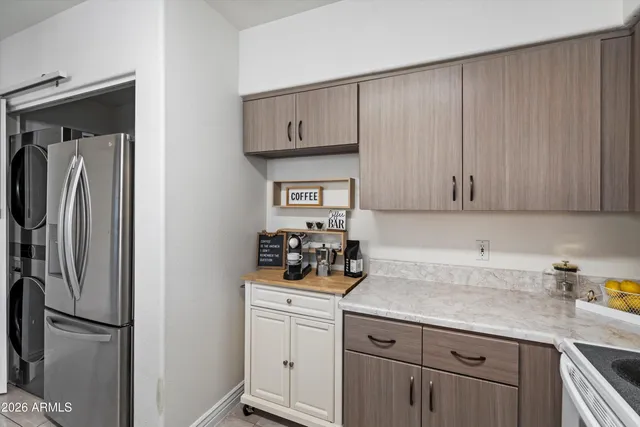 a kitchen with a refrigerator and cabinets