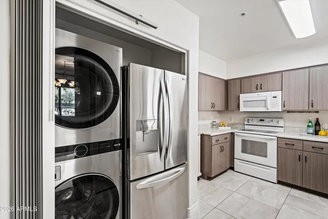a kitchen with a refrigerator and washer