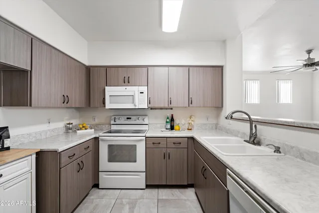 a kitchen with white cabinets stainless steel appliances and sink