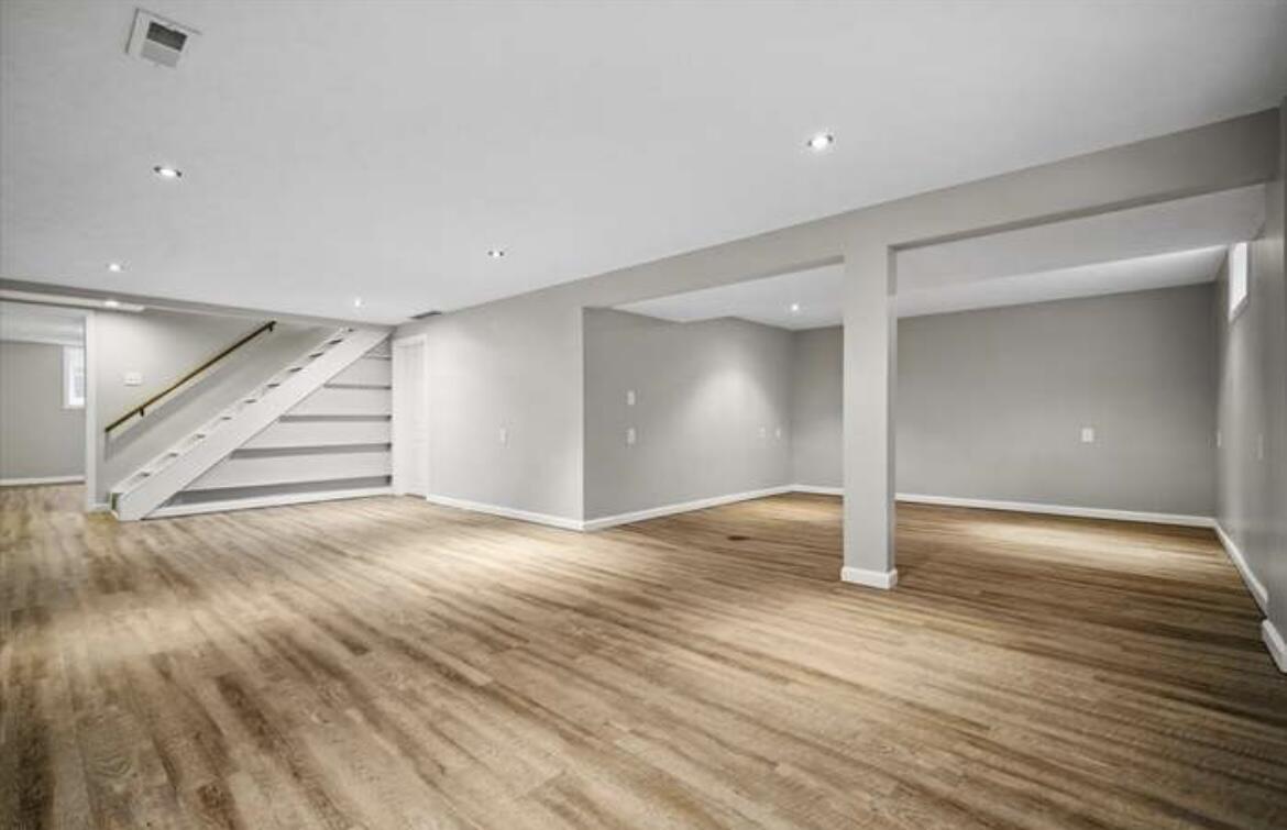 1014 Franklin Avenue Normal, IL 61761 - Photo 5 of 6 a view of an empty room with wooden floor and stairs