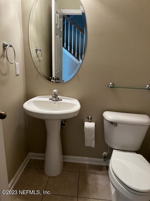 3121 East Banister Road St. Augustine, FL 32092 - Photo 12 of 31 a bathroom with a toilet sink and mirror