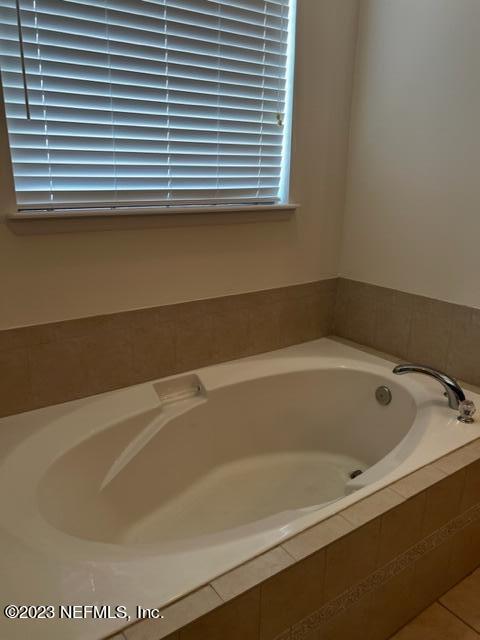3121 East Banister Road St. Augustine, FL 32092 - Photo 17 of 31 a bath tub sitting in a bathroom next to a window
