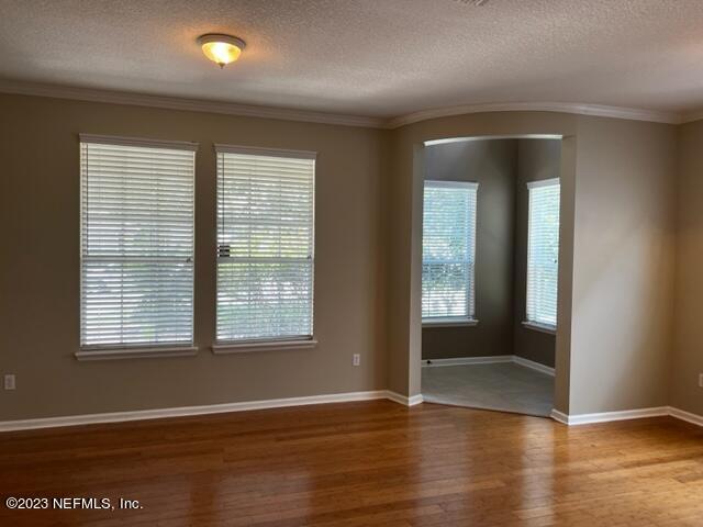 3121 East Banister Road St. Augustine, FL 32092 - Photo 2 of 31 an empty room with wooden floor and windows