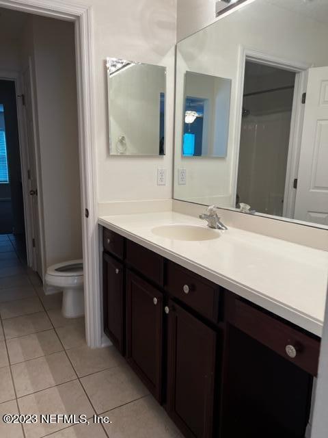 3121 East Banister Road St. Augustine, FL 32092 - Photo 21 of 31 a bathroom with a double vanity sink and mirror