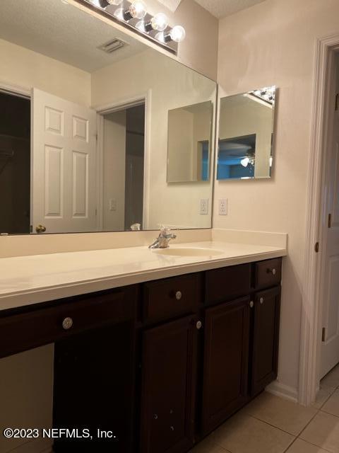 3121 East Banister Road St. Augustine, FL 32092 - Photo 23 of 31 a bathroom with a sink and a mirror