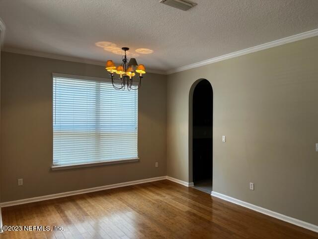 3121 East Banister Road St. Augustine, FL 32092 - Photo 3 of 31 an empty room with wooden floor and a window