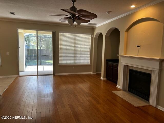 3121 East Banister Road St. Augustine, FL 32092 - Photo 6 of 31 a view of an empty room with a fireplace and a window