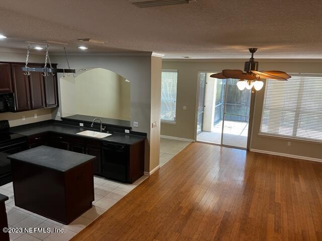 3121 East Banister Road St. Augustine, FL 32092 - Photo 7 of 31 a kitchen with a sink stove and cabinets